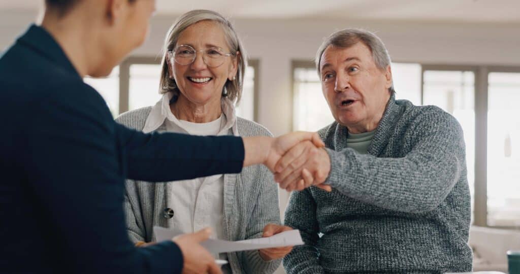 Three adults shaking hands